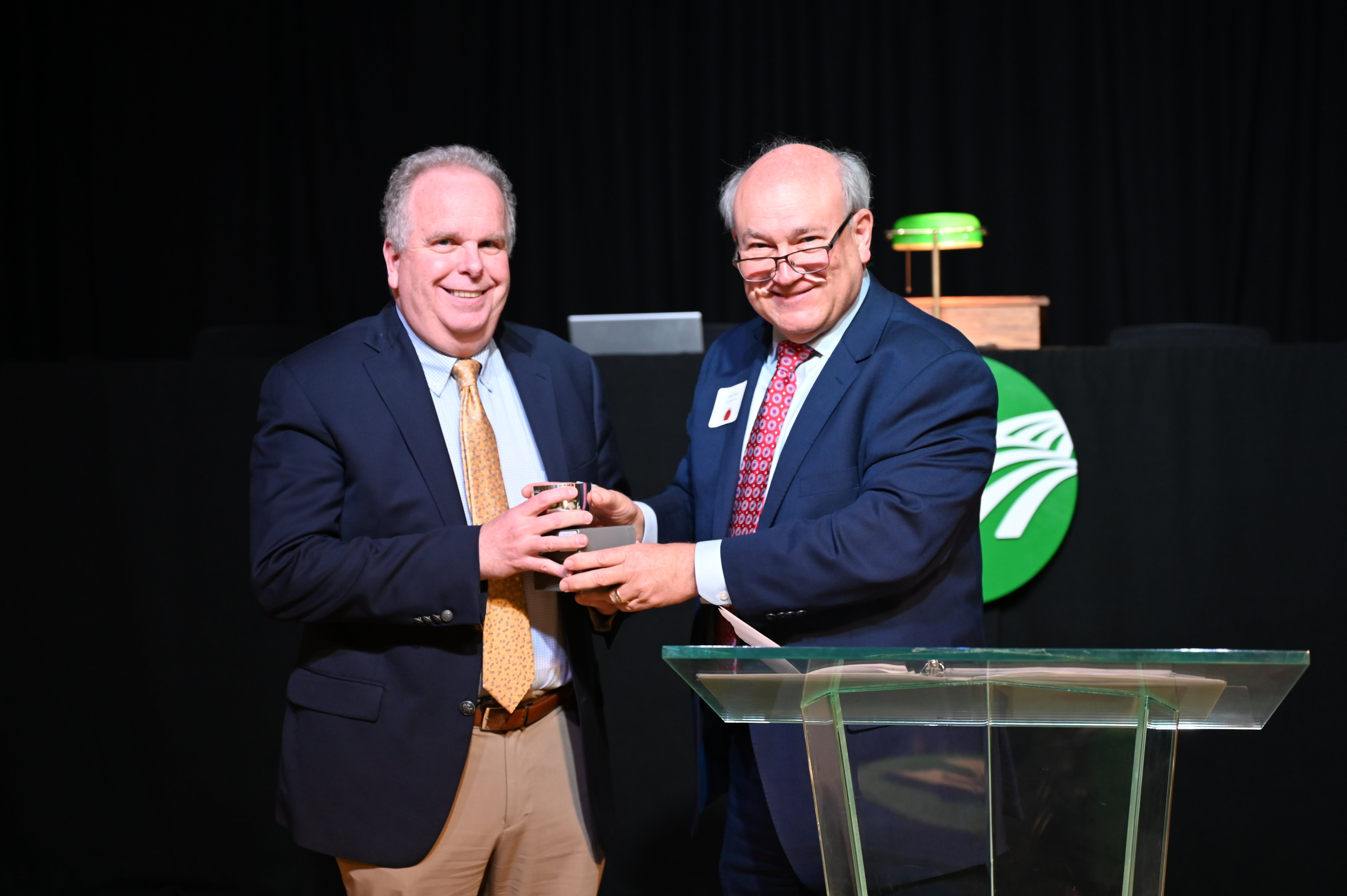 Tim Williams receives the 2025 Distinguished Cooperator award from GreyStone Power President/CEO Gary Miller.